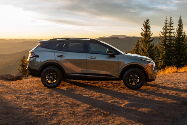 2024 Kia Sportage Parked On A Hill Peak At Sunset Side-View