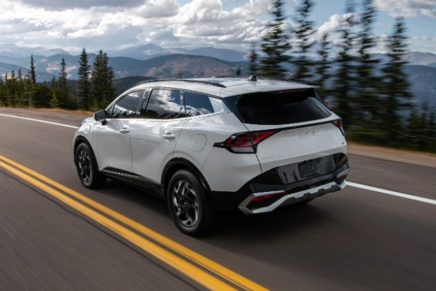 2024 Kia Sportage Driving On An Elevated Highway Rear Three-Quarter View