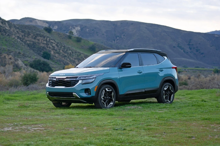 2024 Kia Seltos Speeding Down a Forest Road Side-View